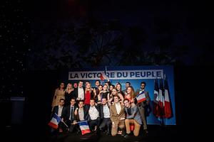 De Europese kandidaat voor het Rassemblement National, Jordan Bardella (m.) met zijn aanhg, zondag in Parijs. beeld EPA, Christophe Petit Tesson