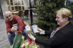 Verwonderd en aangenaam verrast bekijkt het Poolse echtpaar Marian (l.) Wiecha en Inga (r.) Najgebauer de inhoud van hun eindejaarspakket.  beeld Vidiphoto
