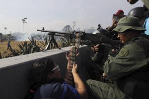 epa07538288 Members of the Bolivarian Armed Forces with firearms participate during in a demonstration in Caracas, Venezuela, 30 April 2019. Reports state that at least one person was injured during the clashes at La Carlota after Guaido called for mass anti-government protests backed by the military. Venezuelan interim President Juan Guaido has asked supporters to take to the streets in order to end the regime of President Nicolas Maduro. Meanwhile, Venezuelan opposition leader Leopoldo Lopez was freed from his house arrest, appearing alongside Guaido and military forces in Caracas. EPA/Miguel Gutierrez