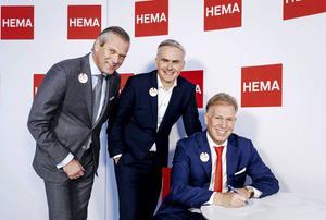 Zakenman Marcel Boekhoorn (r.), Paul Loeff van franchisevereniging VAB en CEO Tjeerd Jegen van Hema tekenen het contract van de overname van HEMA.  beeld ANP ROBIN VAN LONKHUIJSEN