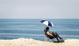 Bellen met de baas op het strand onder de parasol wordt steeds gewoner. Twee op de vijf werknemers –40 procent– wordt tijdens de vakantie gebeld of gemaild door het werk. Negen jaar geleden was dat nog maar 25 procent. beeld ANP, Remko de Waal