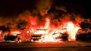 In brand gestoken auto's bij demonstraties in Kenosha, Wisconsin, maandag. beeld EPA, Tannen Maury